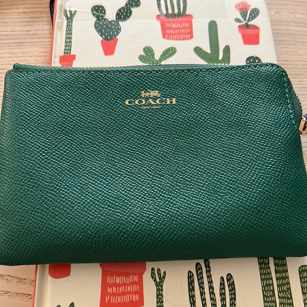 Coach used but with a ton of life wristlet